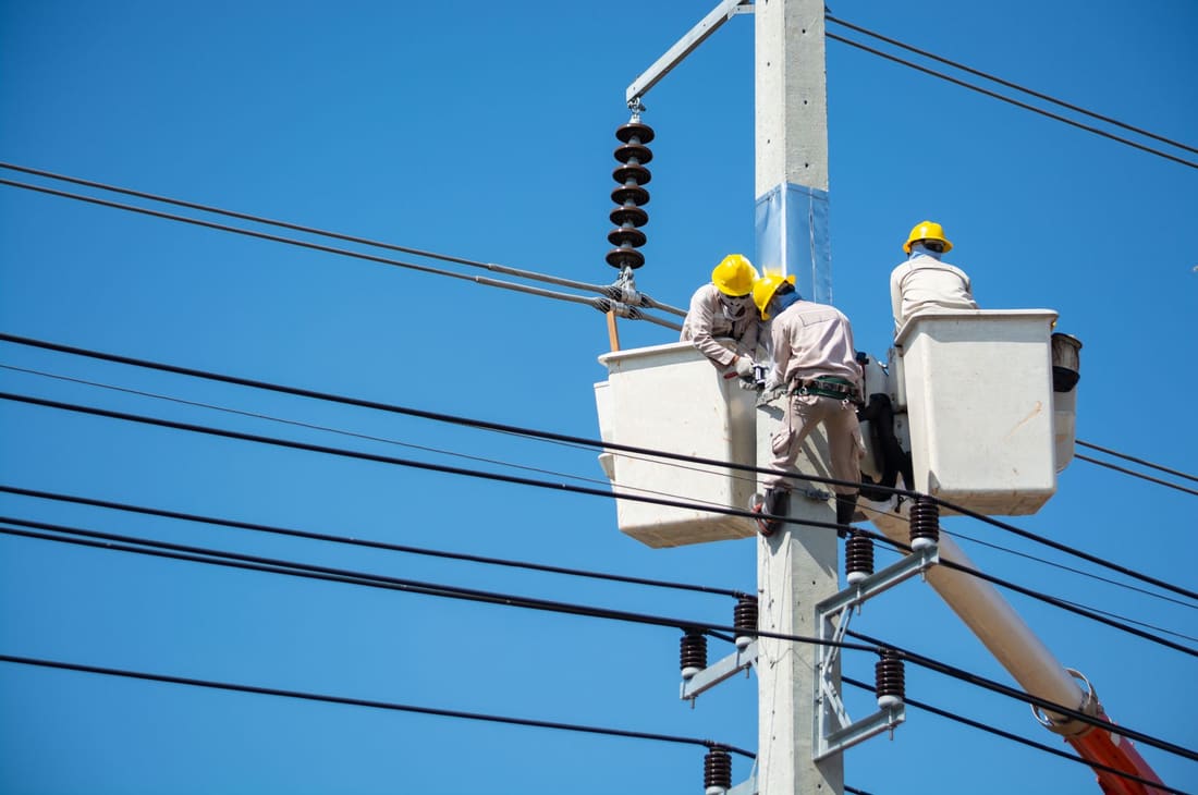 Crew working on overhead distribution during construction